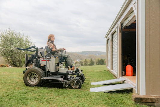 A woman driving a vehicle up a ramp.