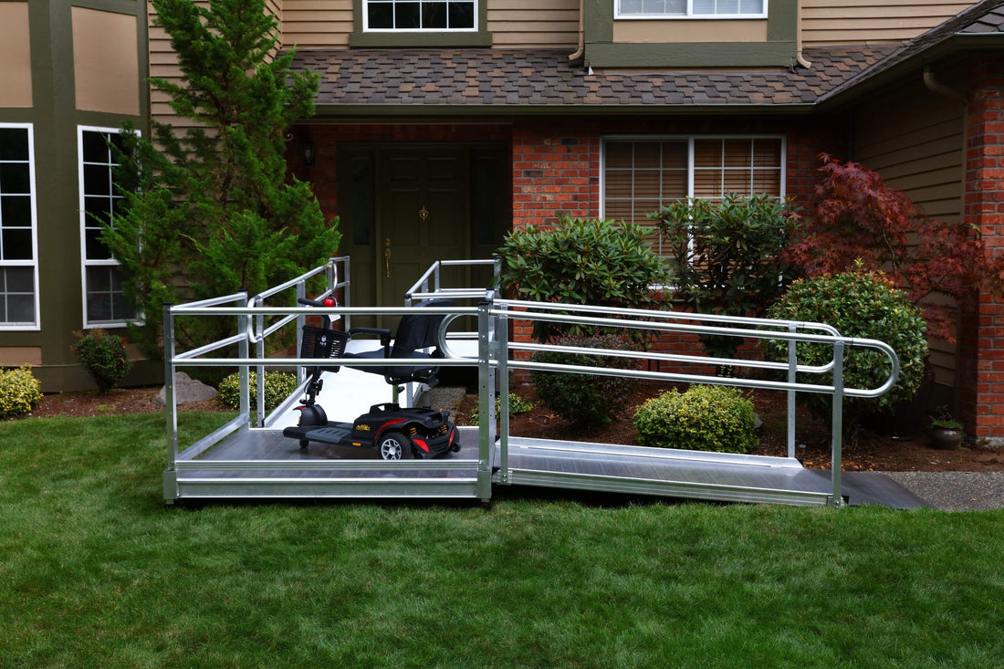 A PATHWAY 3G Modular Access System leading up to the front door of a house, with a motorized scooter on the ramp's resting platform
