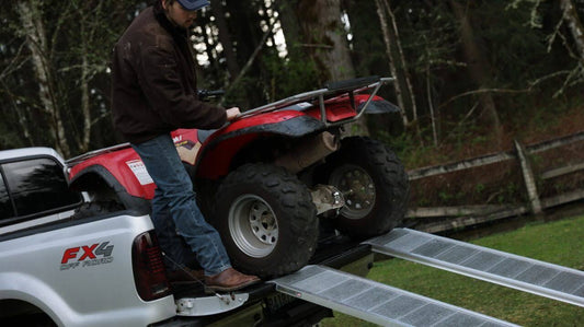 Loading a vehicle on a ramp.