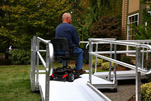 Man in a wheelchair moving up a ramp.