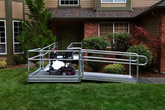 An electric wheelchair on a ramp outside.